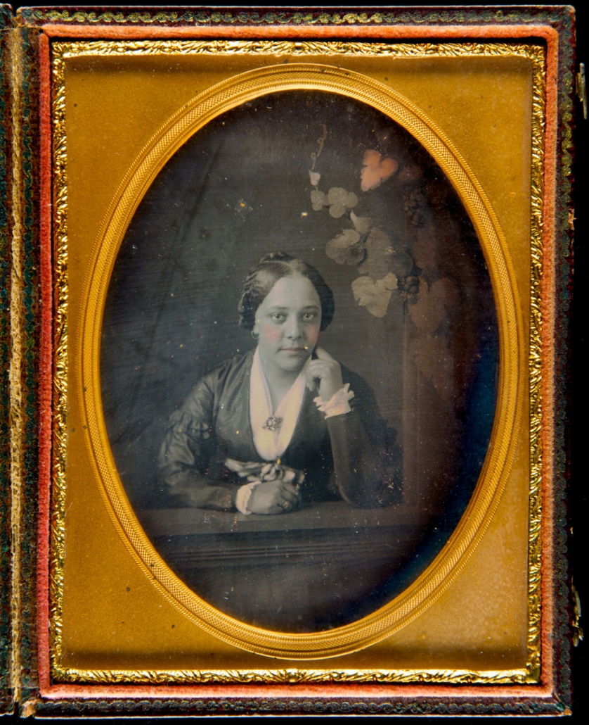 Daguerreotype of African American woman, seated, facing viewer, and with her left hand at her chin